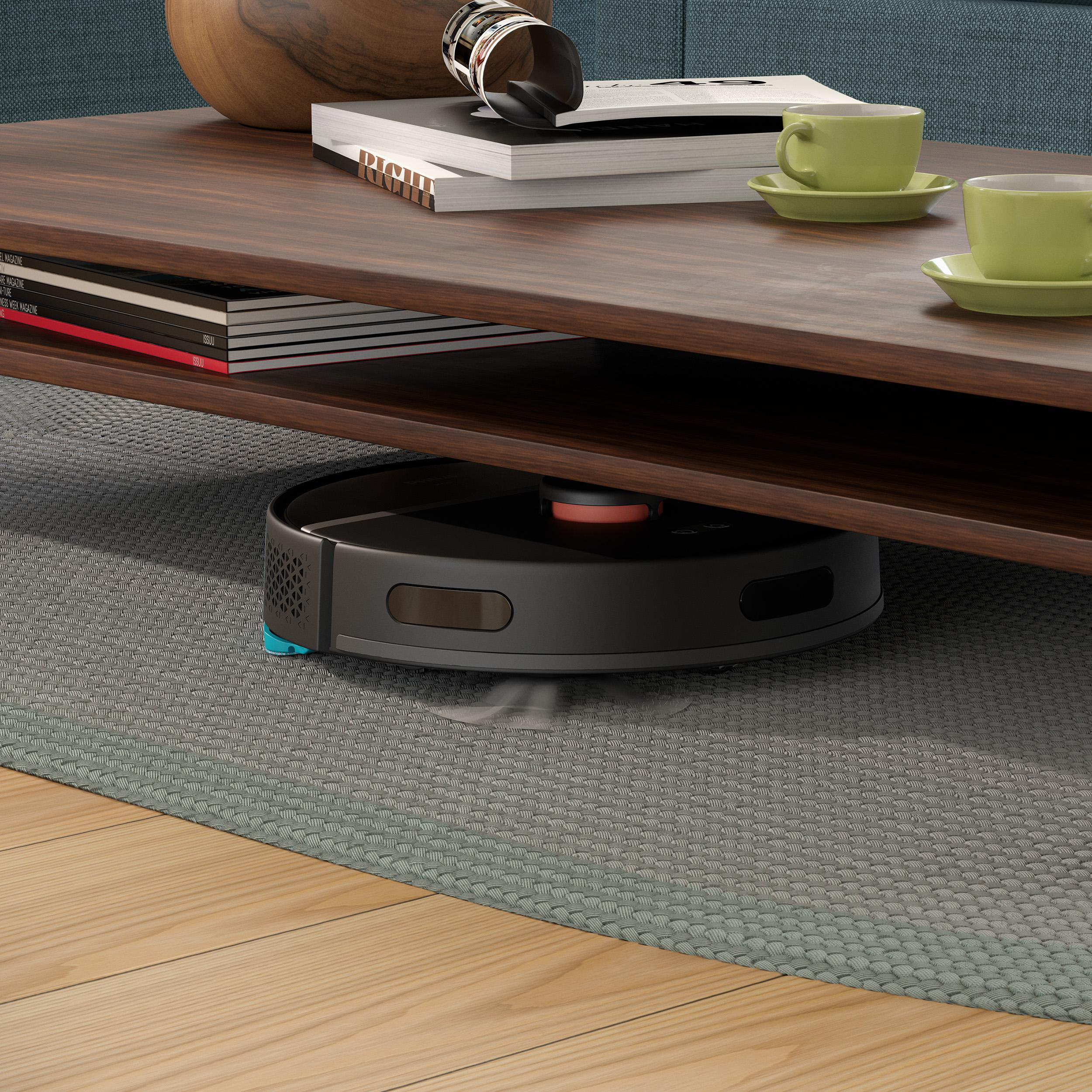 Ein Roboter-Staubsauger reinigt unter einem Couchtisch.