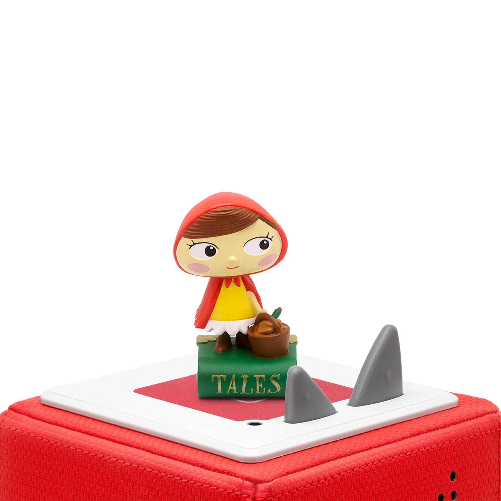Eine Rotkäppchen-Figur auf einer roten und grünen Schachtel. Die Figur ist ein Cartoon-Mädchen mit einem Korb.