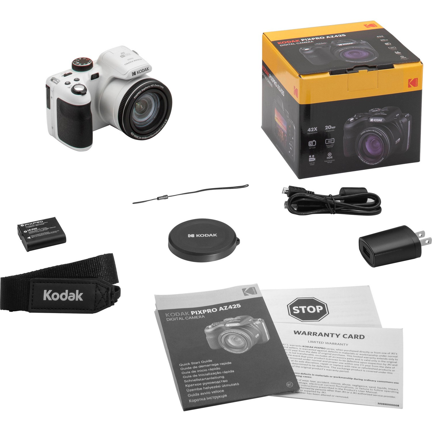 Appareil photo Kodak blanc sur une surface blanche avec boîte, accessoires et documents.