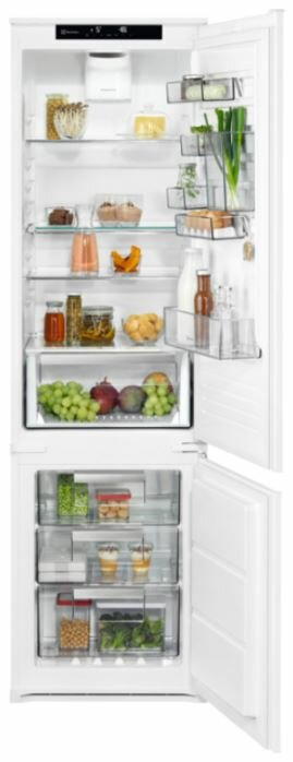 Biała lodówka, otwarta, wypełniona produktami spożywczymi na półkach i w szufladach.