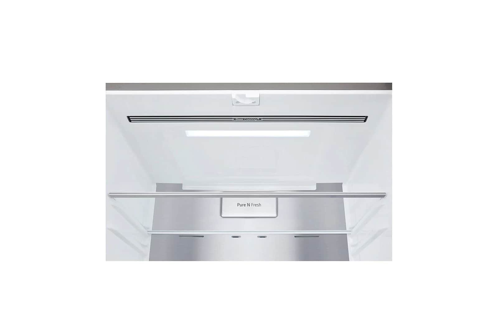 Wnętrze lodówki z półką i światłem. Zbliżenie na górną część lodówki.