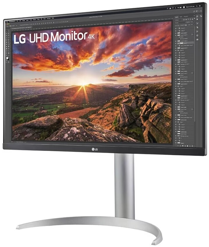 Monitor LG UHD 4K, z malowniczym krajobrazem na ekranie, na srebrnej podstawie.