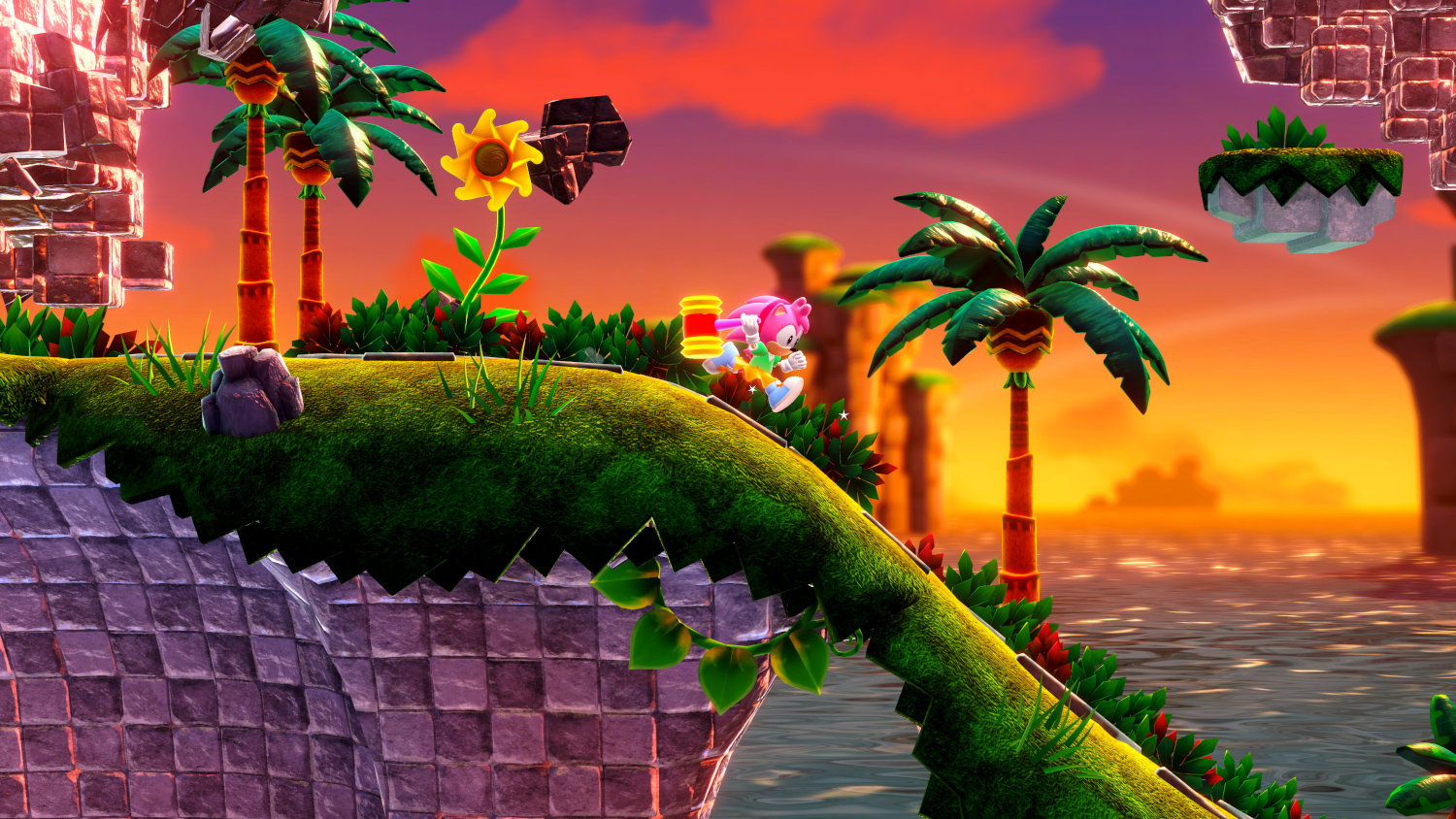 Amy Rose in een game scene, rennend op een groen platform met palmbomen en zonsondergang.
