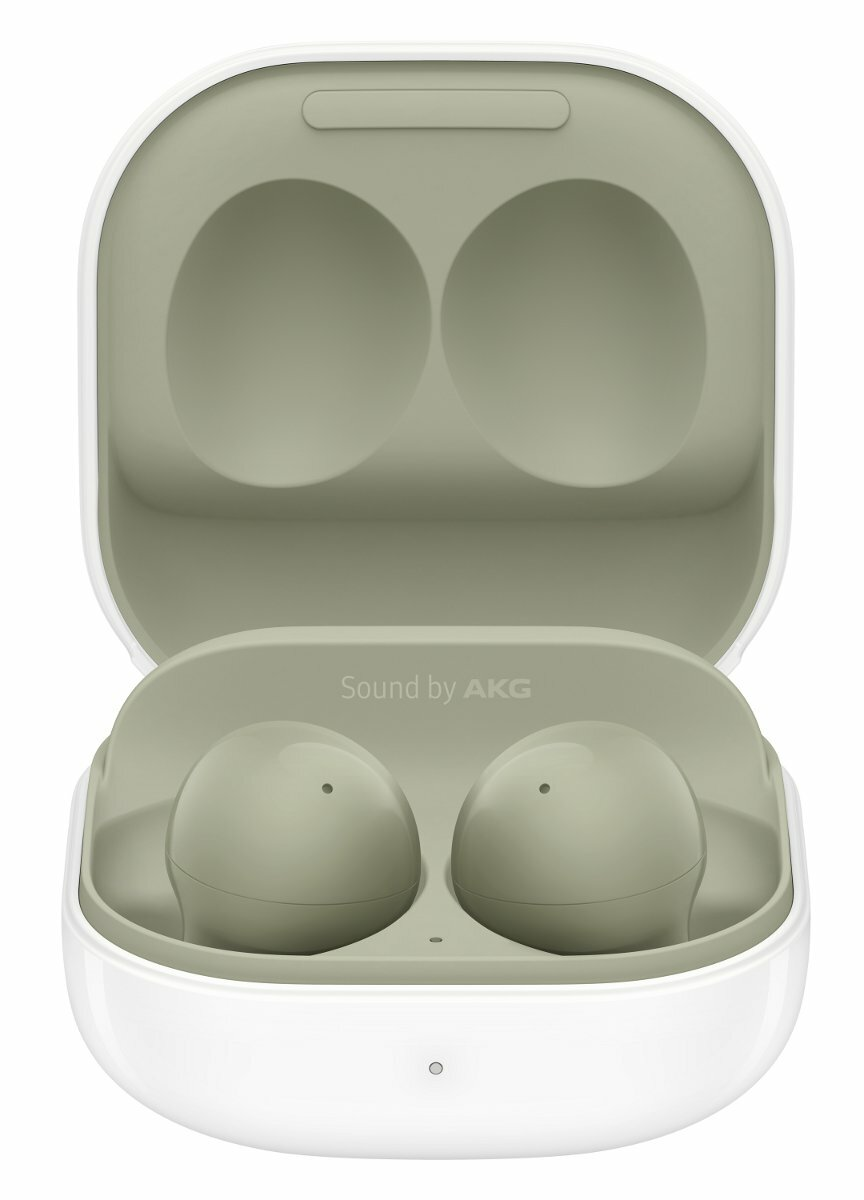 Zielone słuchawki w białym etui. Etui otwarte, widoczne słuchawki.