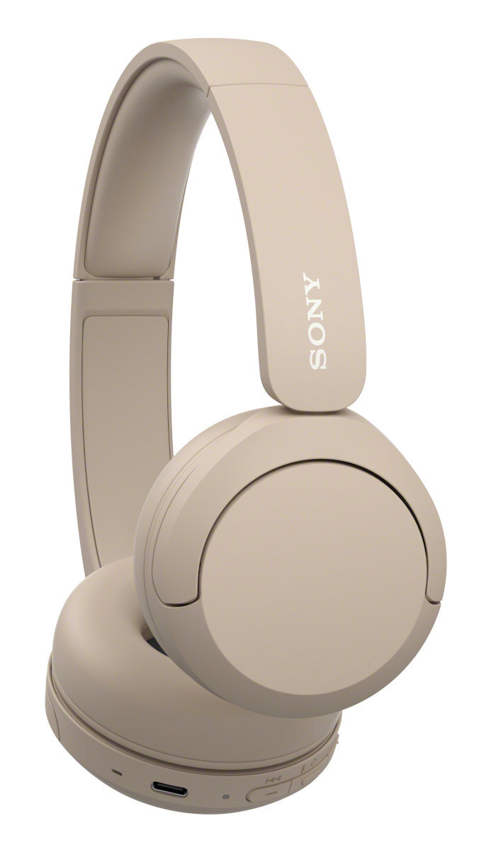 Beżowe słuchawki z zakrzywionym pałąkiem i nausznikami, na białym tle.