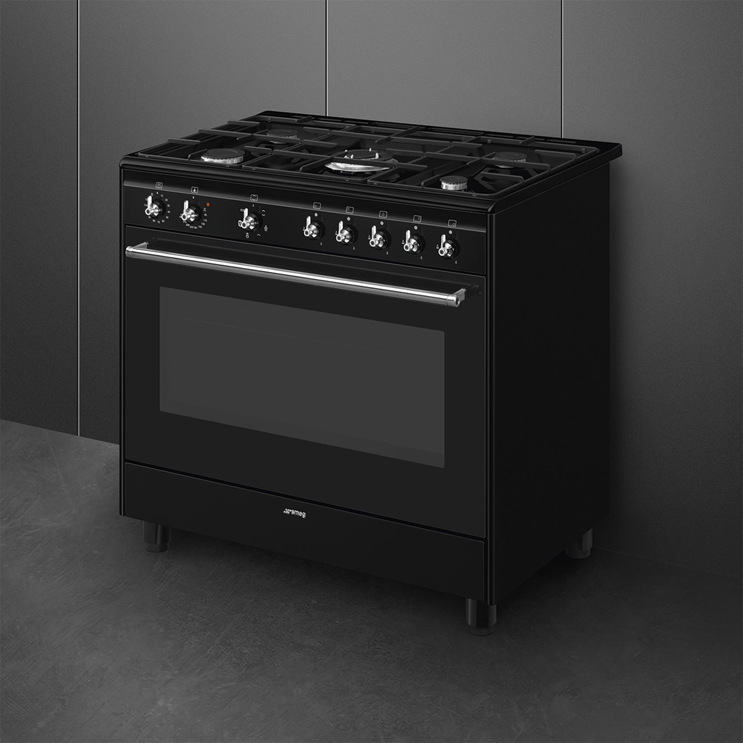 Un fornello a gas Smeg nero con sei bruciatori e un forno. È su uno sfondo grigio.
