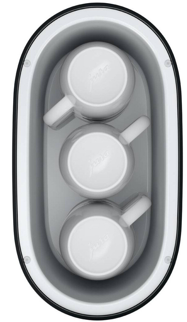 Widok z góry podgrzewacza do filiżanek Jura z trzema białymi filiżankami w owalnej, szarej przegródce.