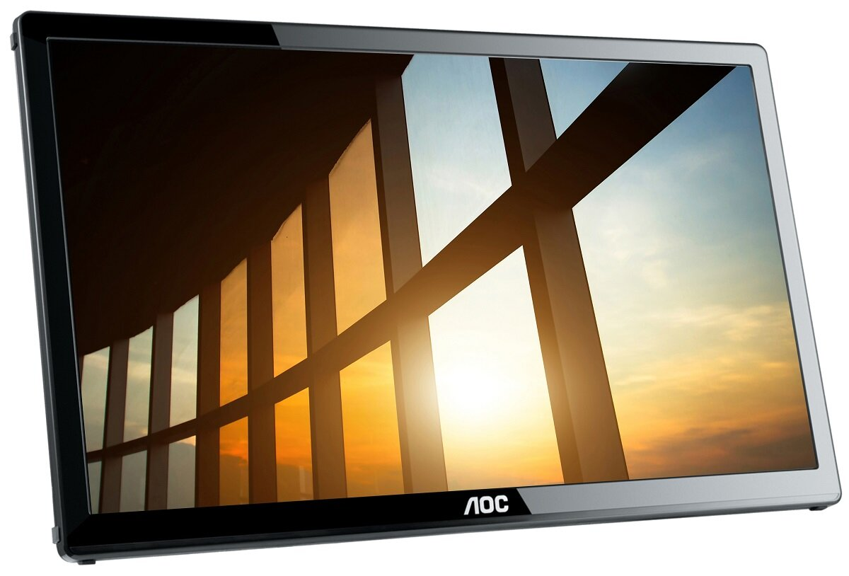 Czarny monitor komputera wyświetlający zachód słońca przez okno.