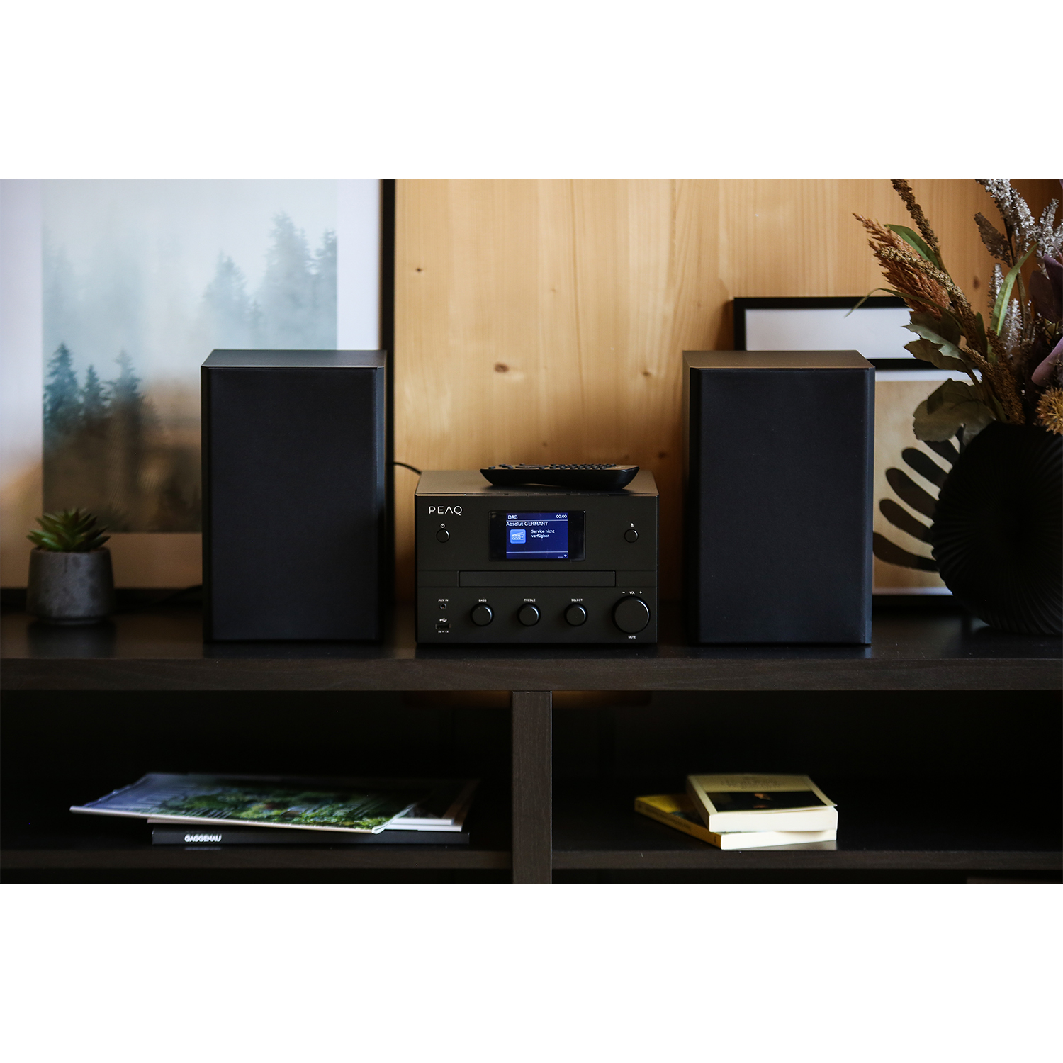 Impianto stereo con due altoparlanti e unità centrale su mensola.