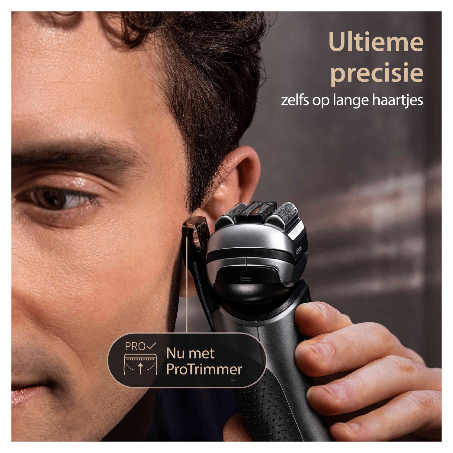 Man shaving with a black and silver Philips shaver.
