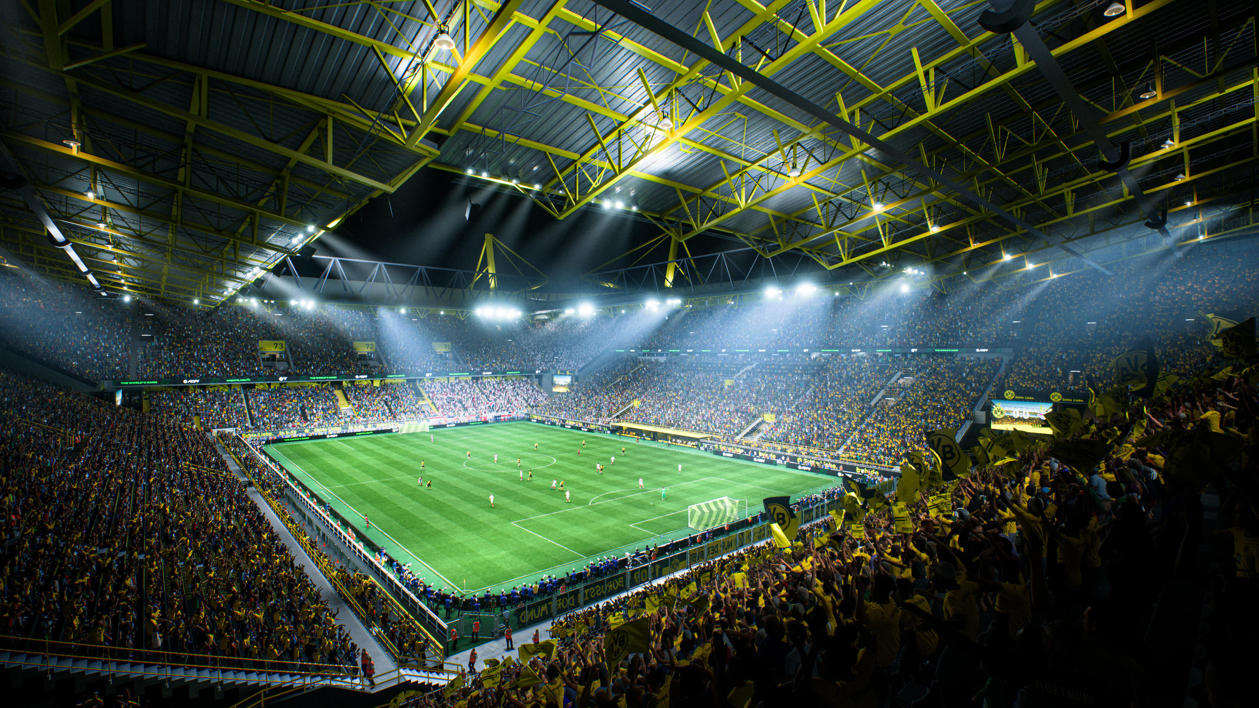 Ein großes Stadion, gefüllt mit Zuschauern, hell für ein Spiel beleuchtet.