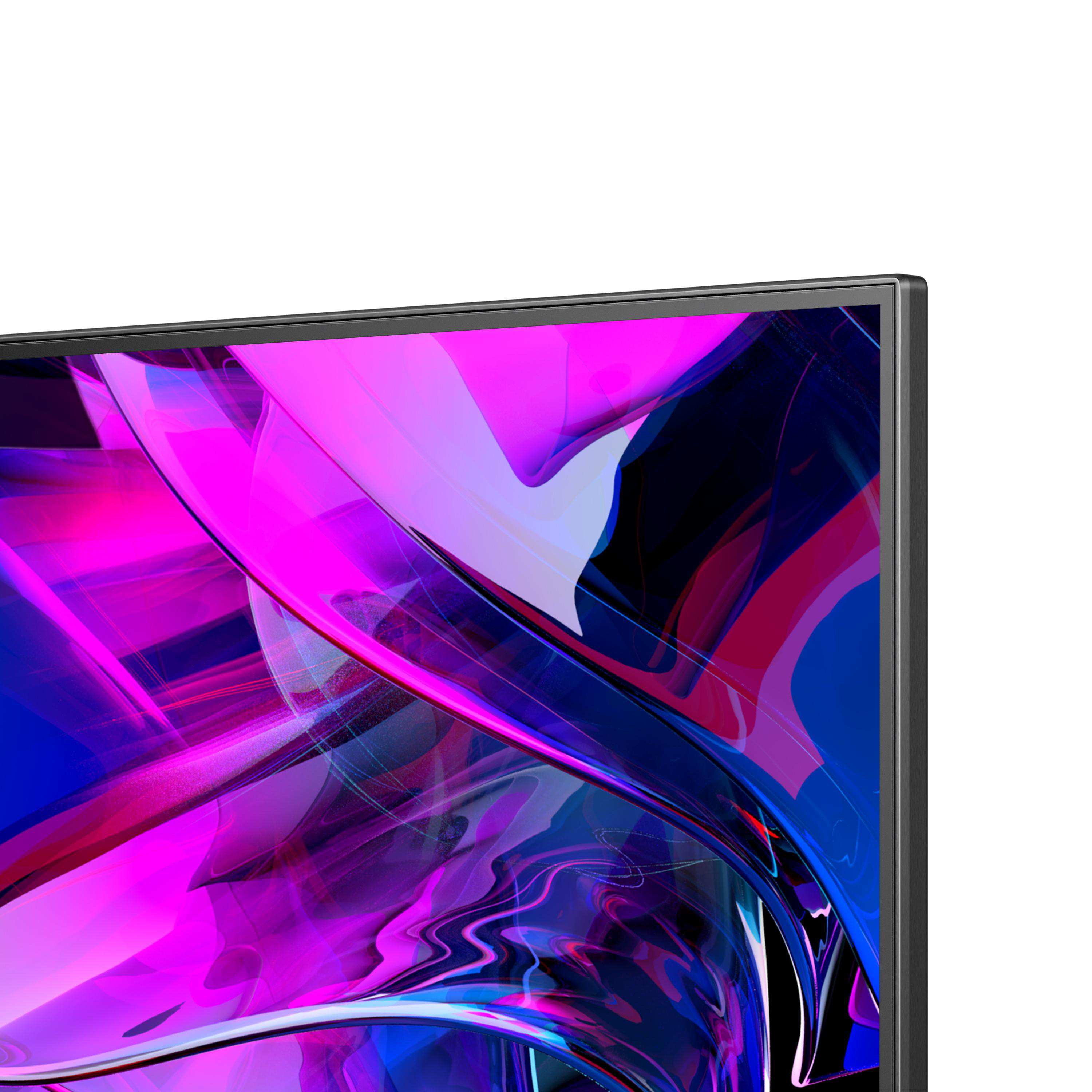 Nahaufnahme eines Fernsehbildschirms mit abstrakten rosa, lila und blauen Formen.