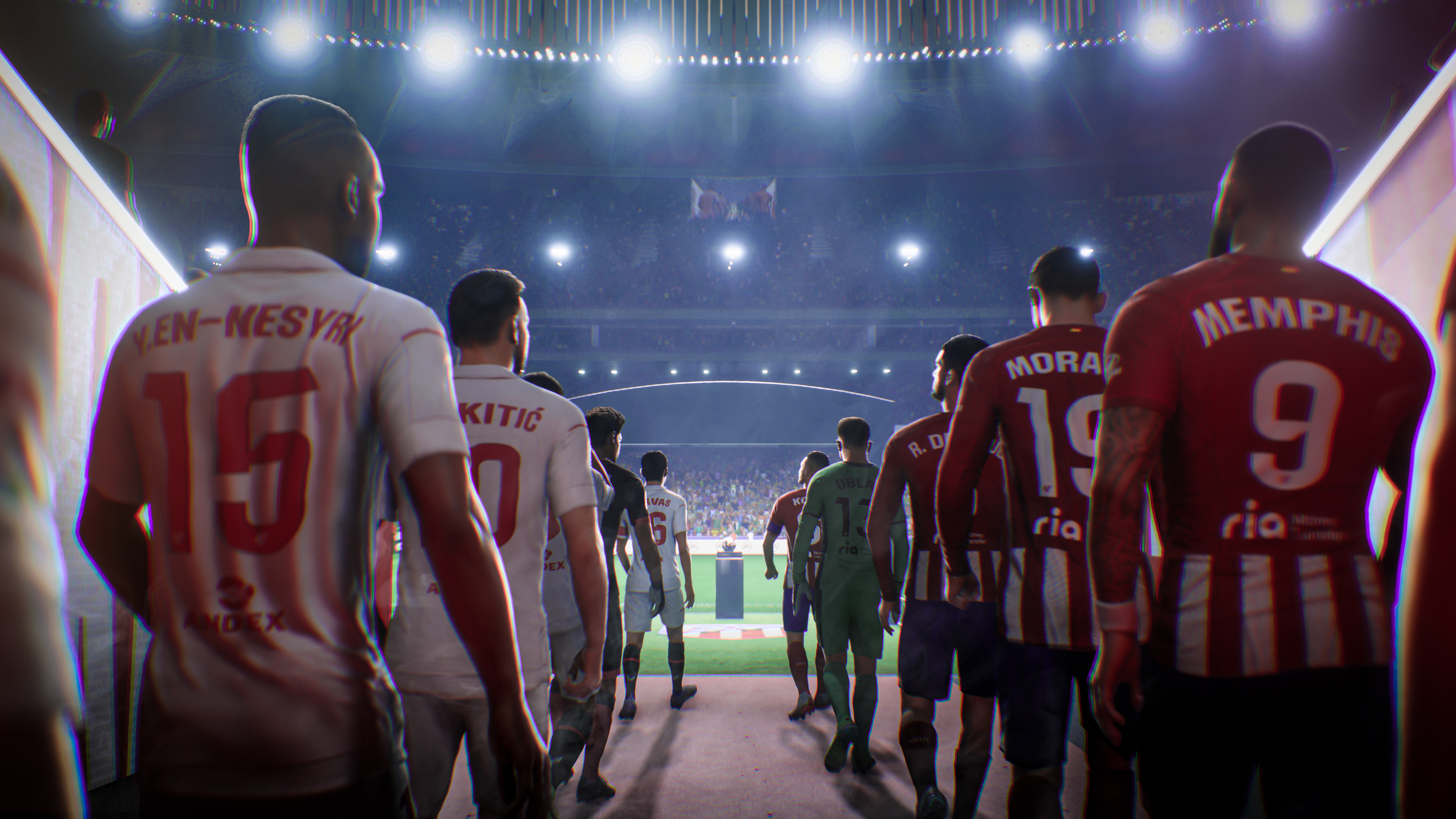 Voetballers lopen door een tunnel naar een felverlicht stadion, rug naar de camera.