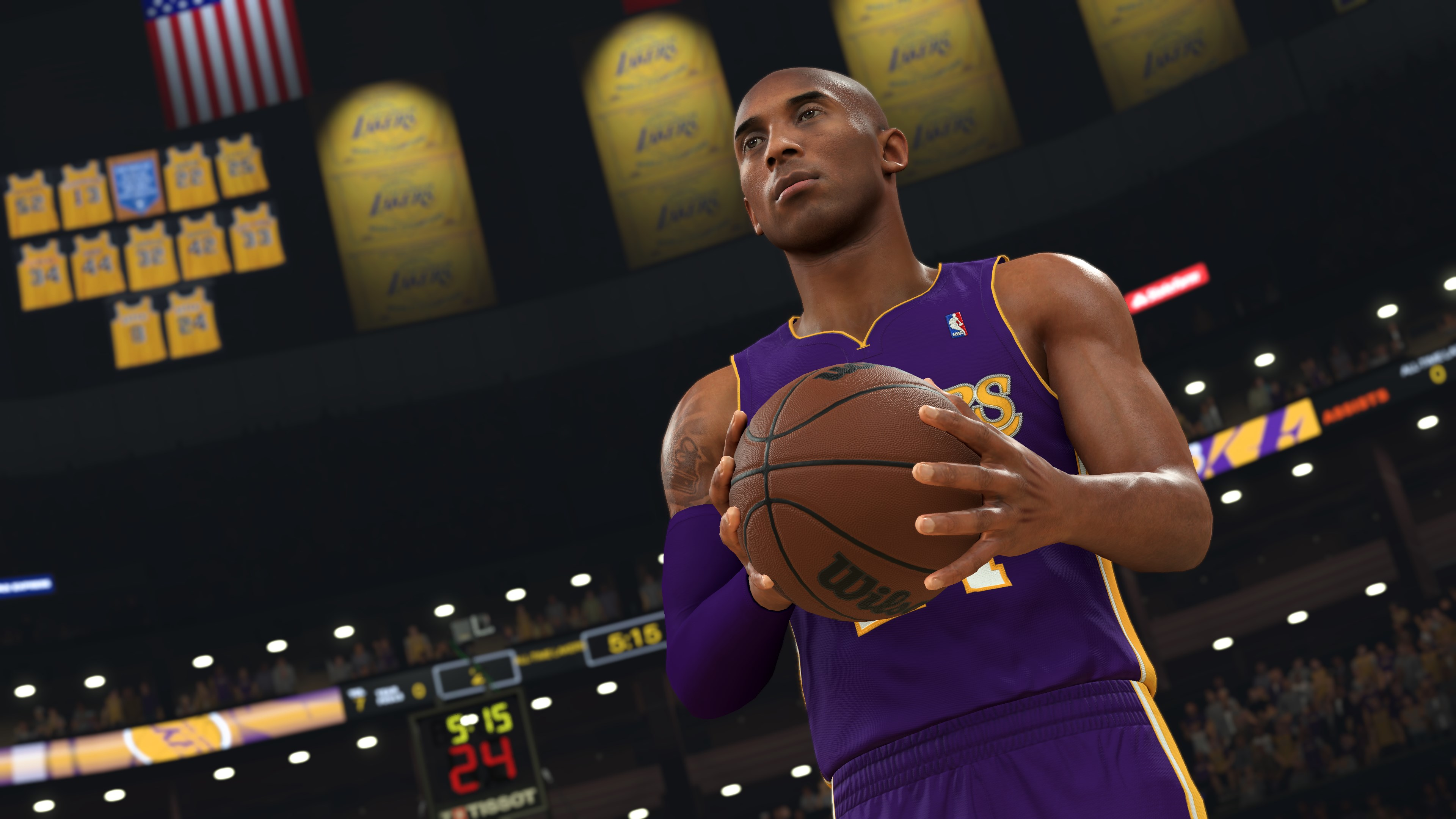 Kobe Bryant en maillot Lakers, tenant un ballon de basket sur un terrain. Bannières en arrière-plan.