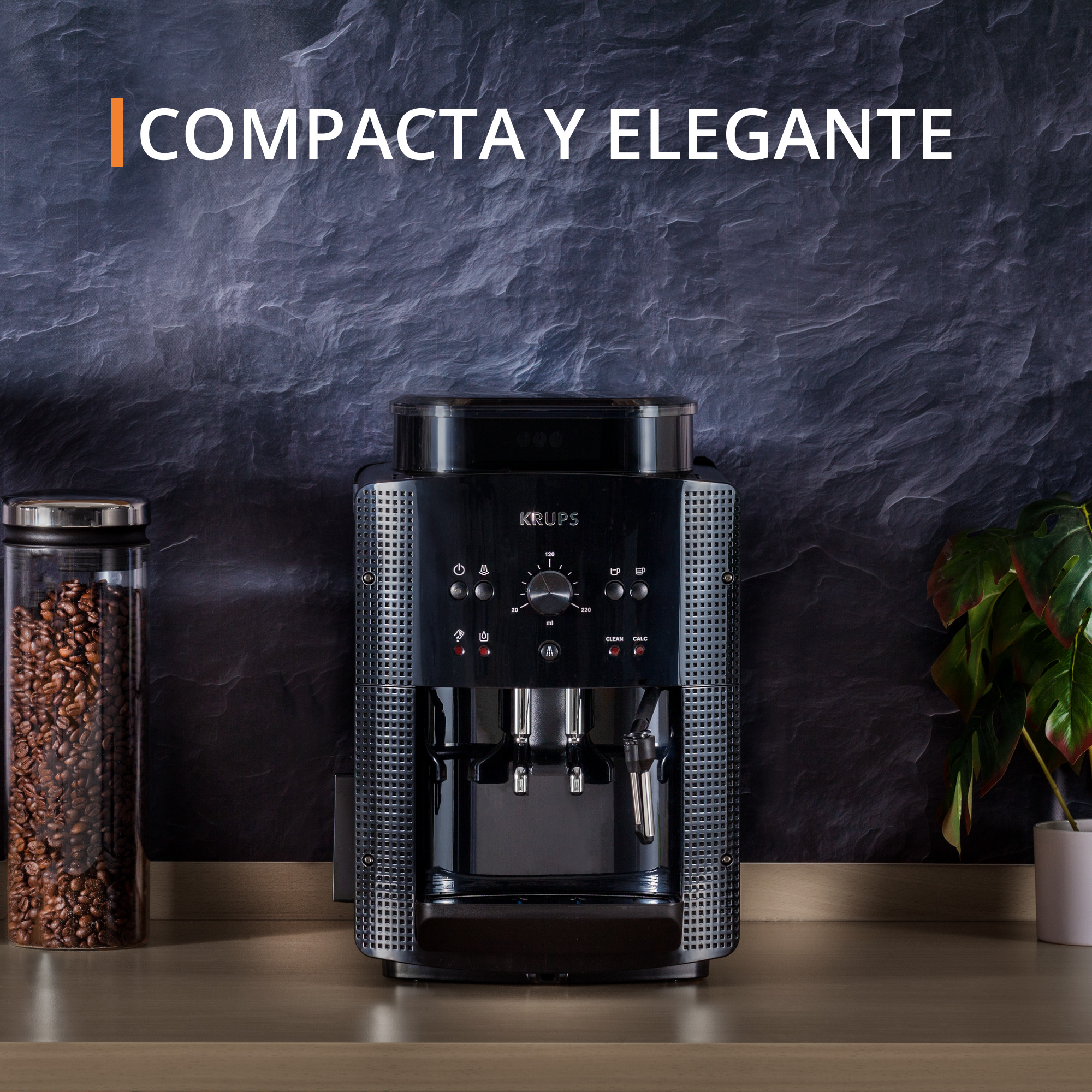 Cafetera Krups negra. Tarro de granos de café, planta y texto: Compacta y Elegante.