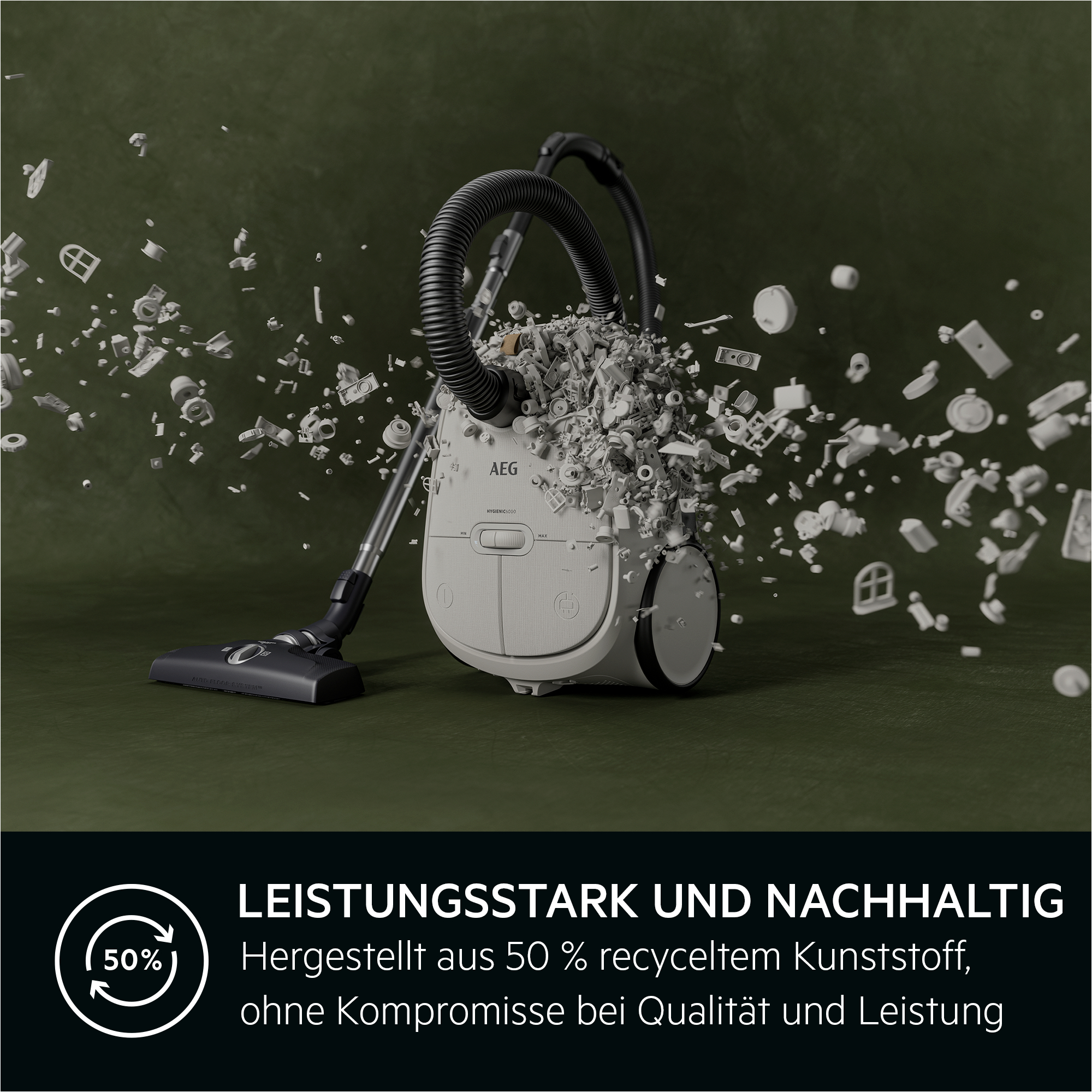 Ein AEG-Staubsauger, der Trümmer aufsaugt, grüner Hintergrund.