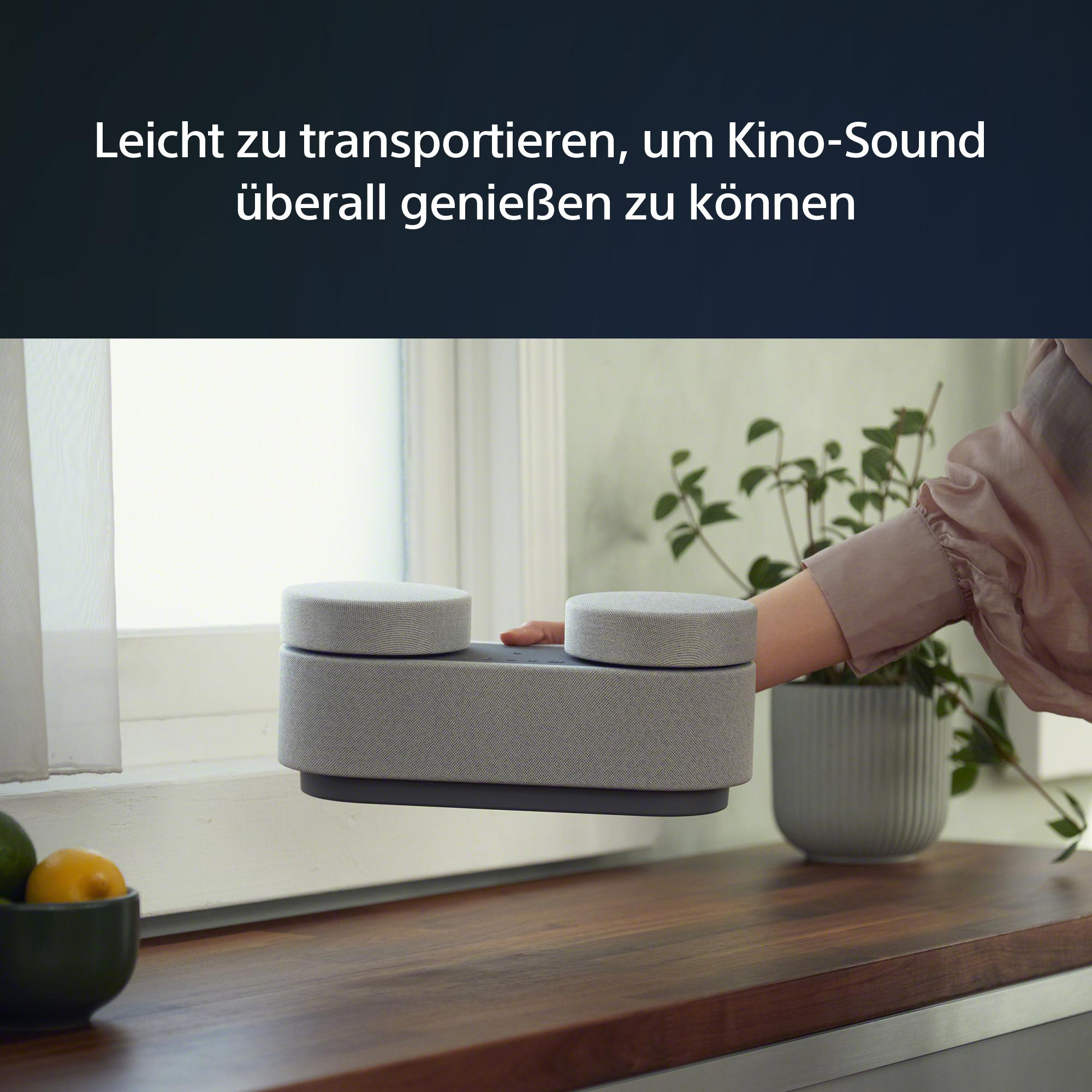 Eine Hand hält einen grauen Lautsprecher. Text oben: Einfach zu transportieren.