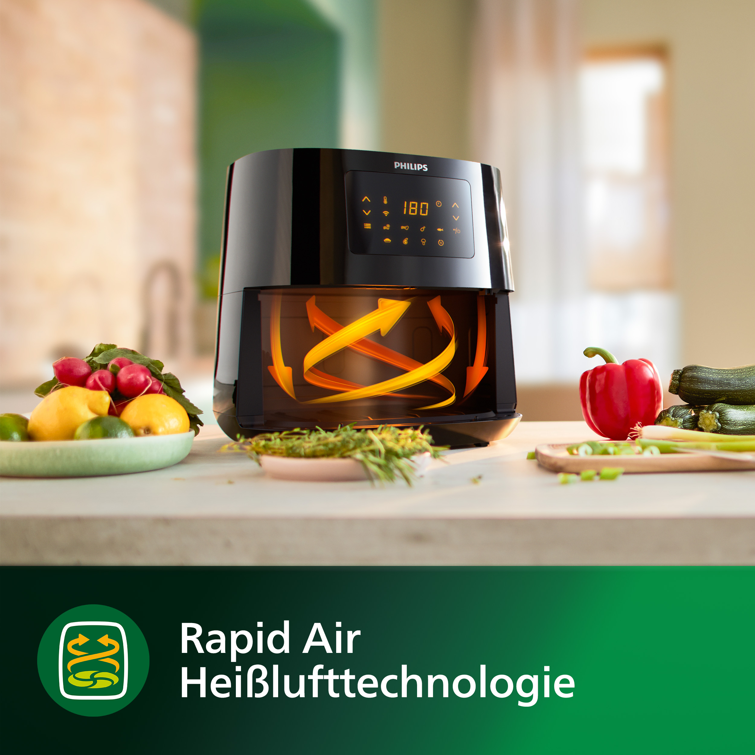 Schwarze Philips Heißluftfritteuse mit Display und Essen drumherum: Zitronen, Radieschen, Zucchini und Paprika.