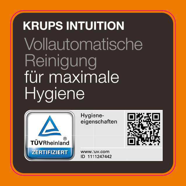 Krups Intuition Etikett mit Text und Zertifizierungslogo, vor orangefarbenem Hintergrund.