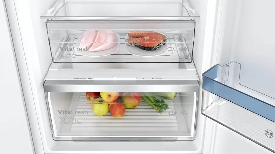 Interior del refrigerador con carne fresca y verduras dentro de los cajones.