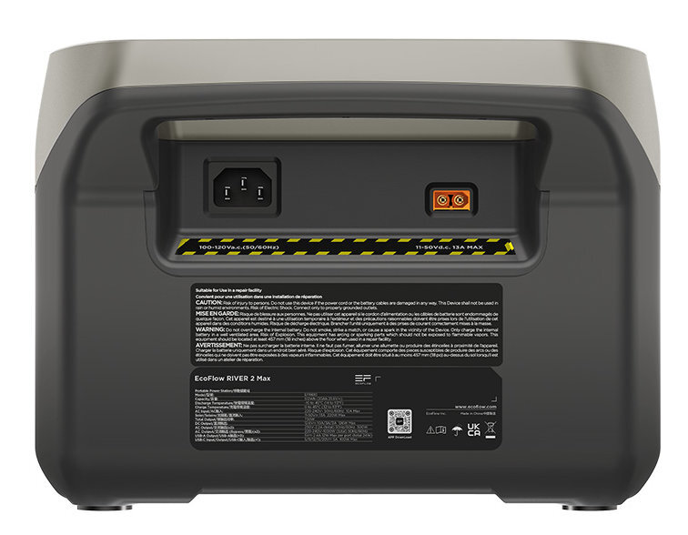 Widok z tyłu czarnej przenośnej stacji zasilania z portami i etykietami ostrzegawczymi.