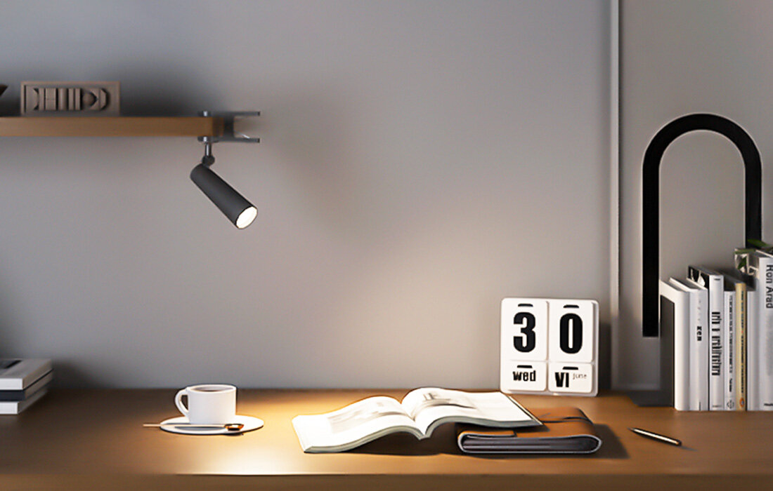 Konfiguracja biurka: książka, kawa, lampa i cyfrowy kalendarz z wyświetloną środą, VI, 30.