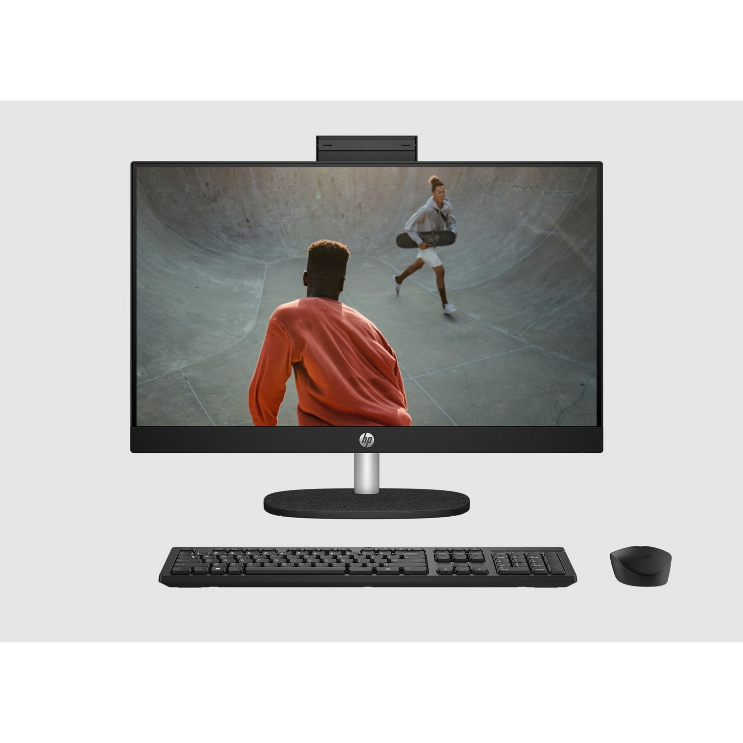 An all-in-one computer showing a video of two people skateboarding.