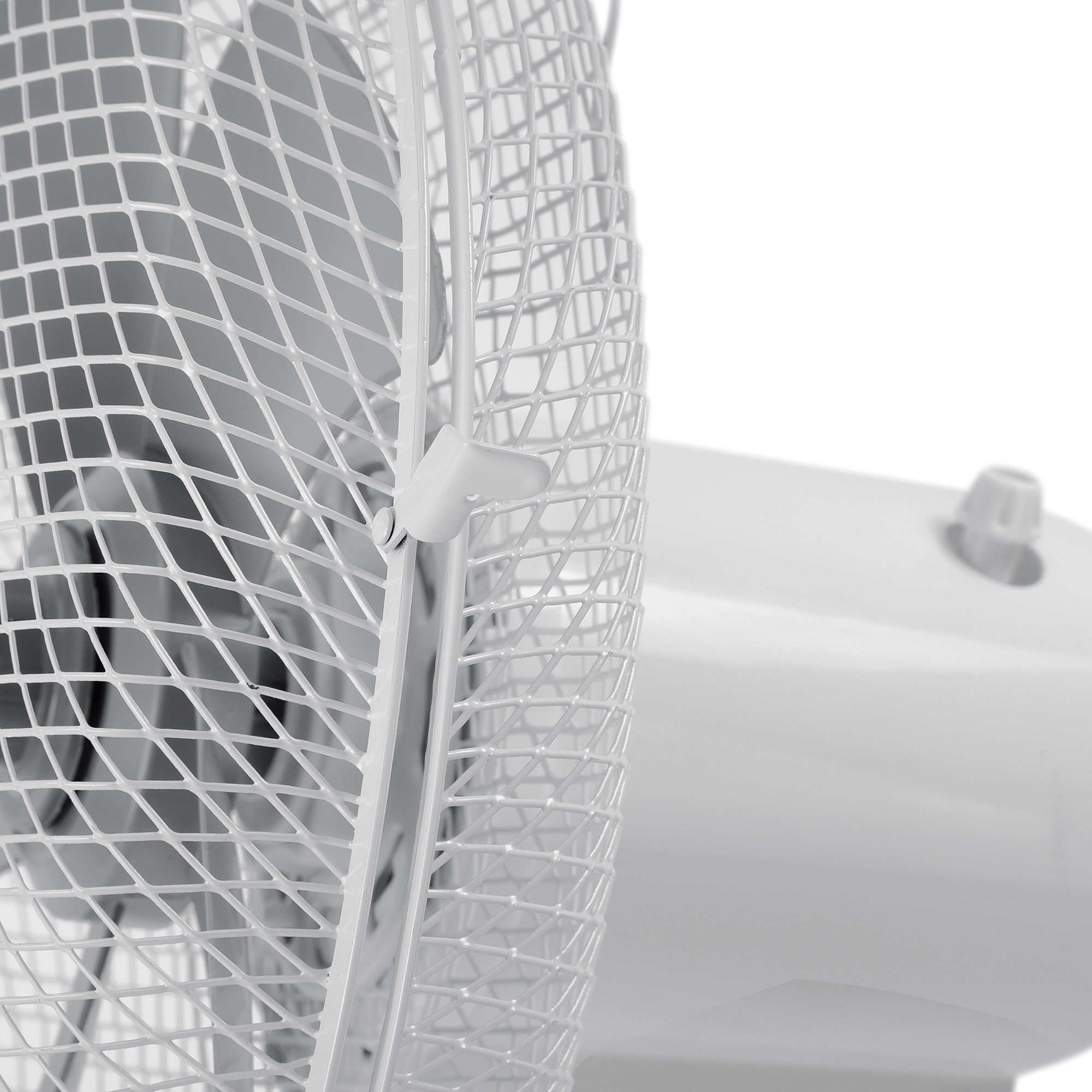 Un primer plano de un ventilador blanco con una rejilla protectora.