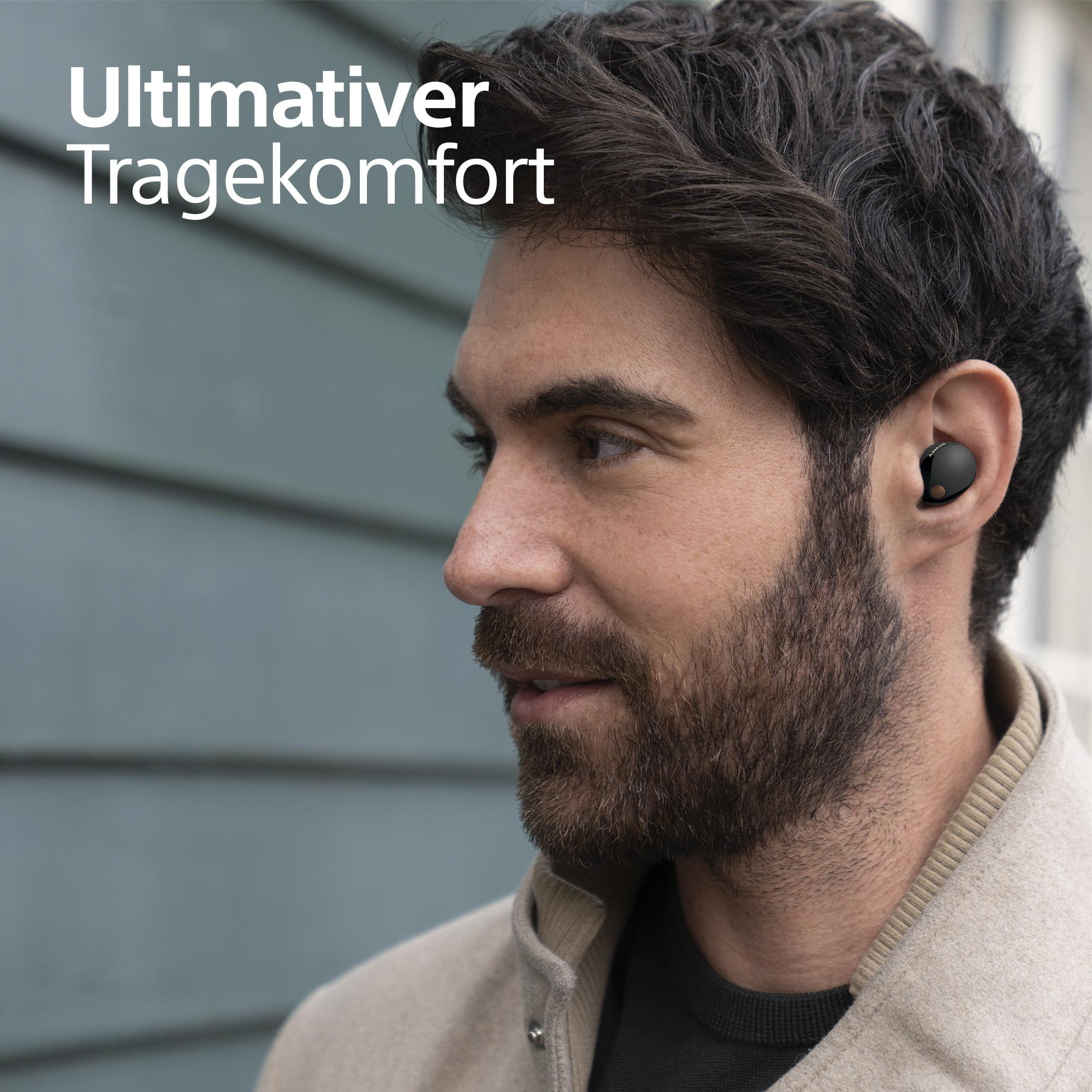 Mann mit schwarzem Ohrhörer, Text "Ultimativer Tragekomfort".