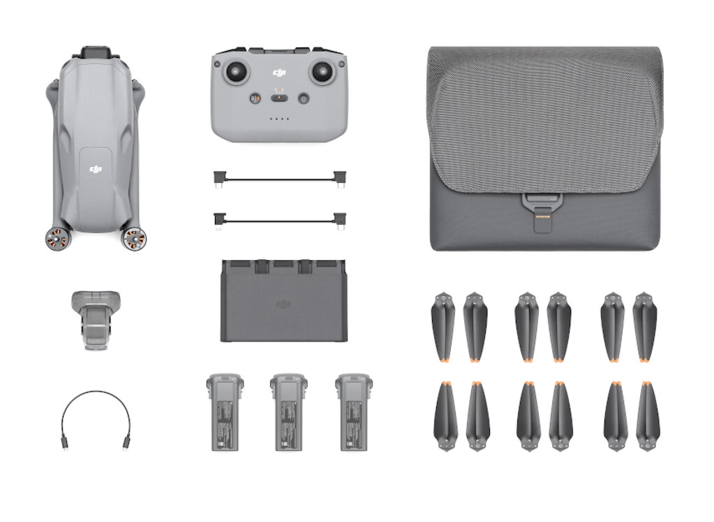 Zestaw drona z dronem, pilotem, śmigłami, bateriami i torbą. Szare kolory na białym tle.