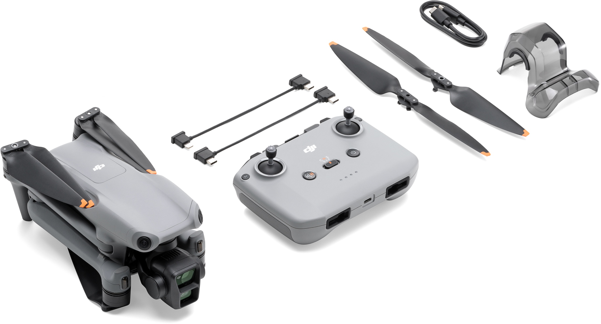 Drohne, Controller, Propeller und Zubehör auf weißer Oberfläche angeordnet.