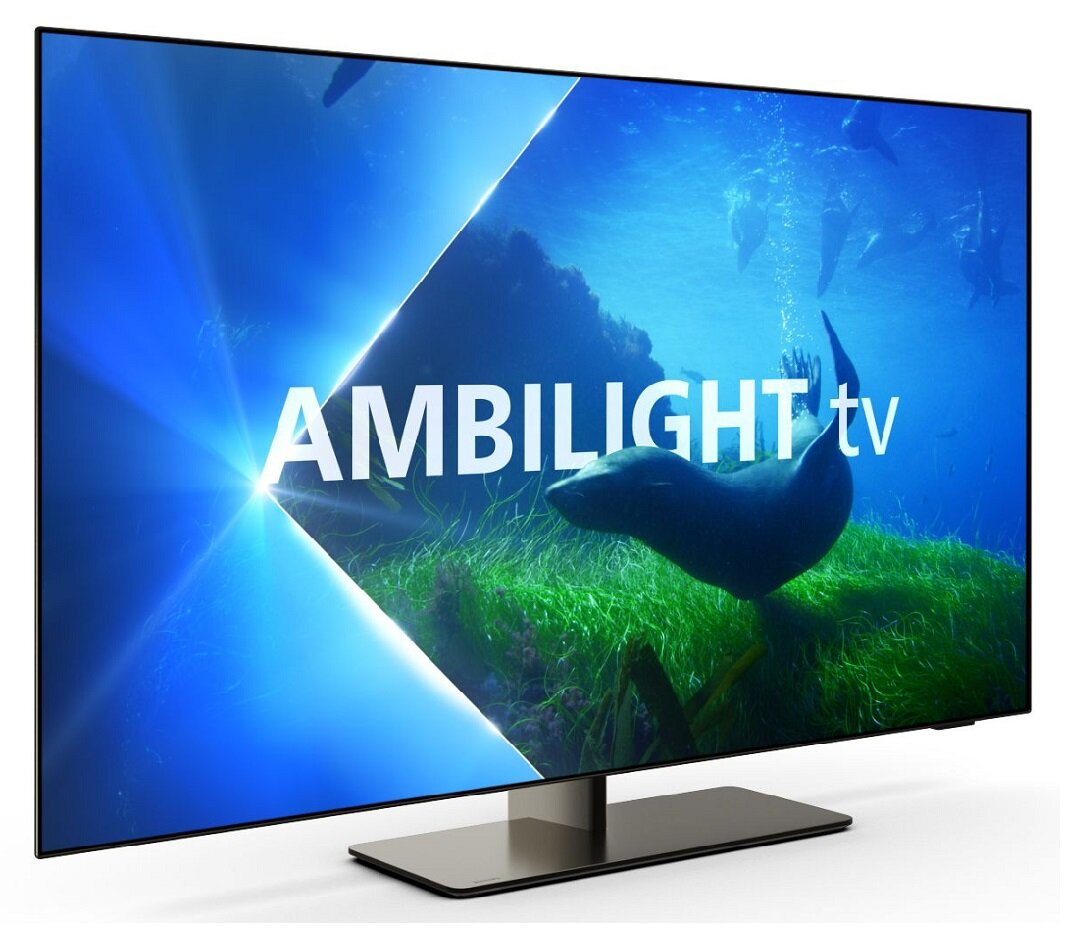 Duży telewizor z płaskim ekranem, widok pod kątem. Wyświetla scenę podwodną. 'Ambilight tv' na ekranie.