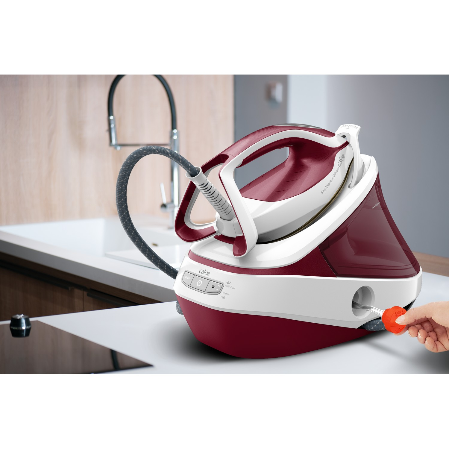 Red and white iron. Hand inserts a water tank filler.