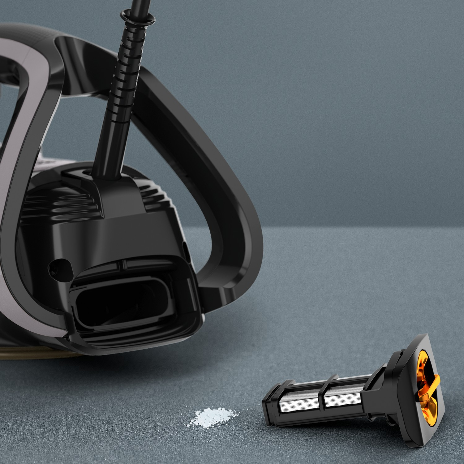 Aspirateur noir avec poignée, filtre et poudre sur une surface grise.