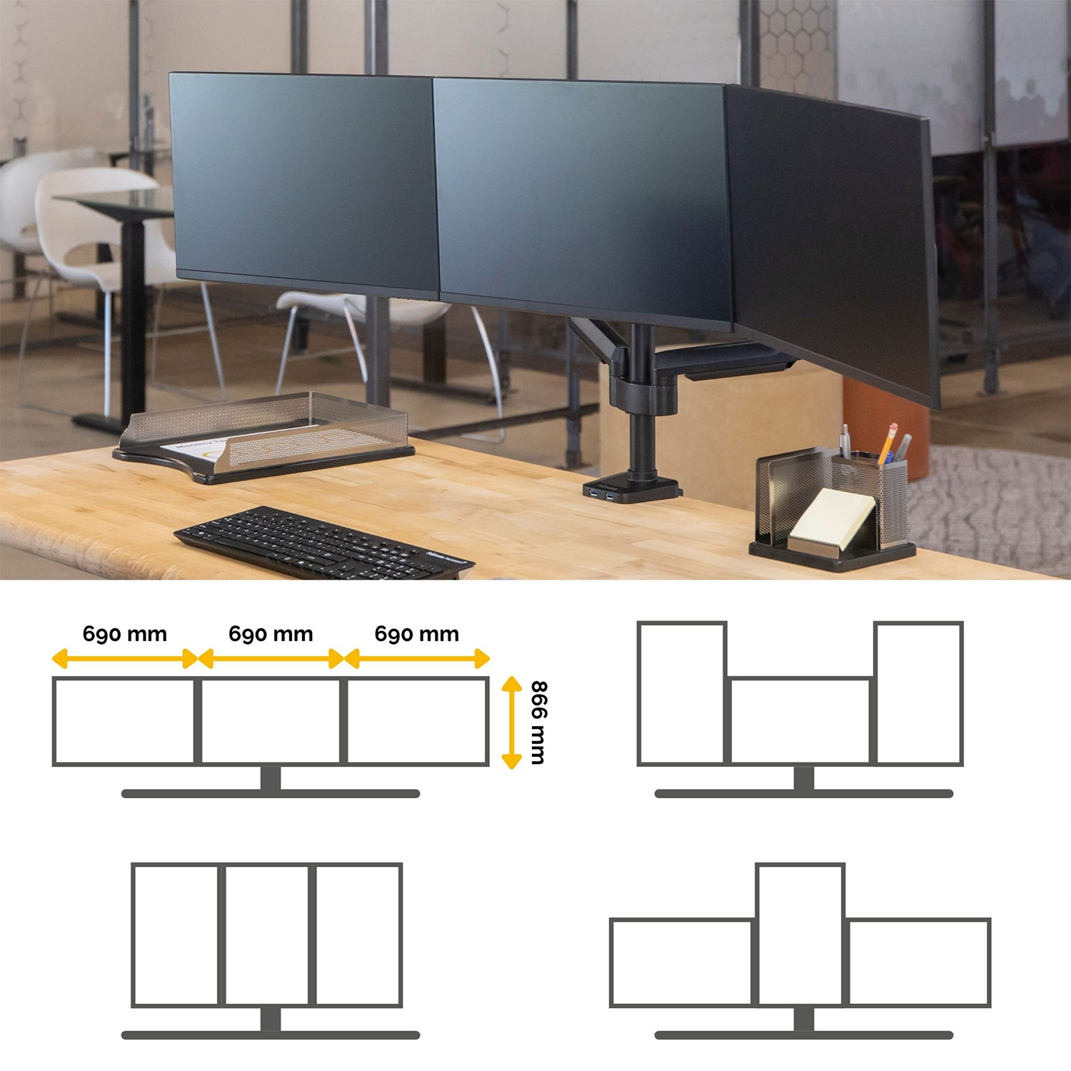Tre monitor per computer montati su una scrivania, con tastiera e altri oggetti.