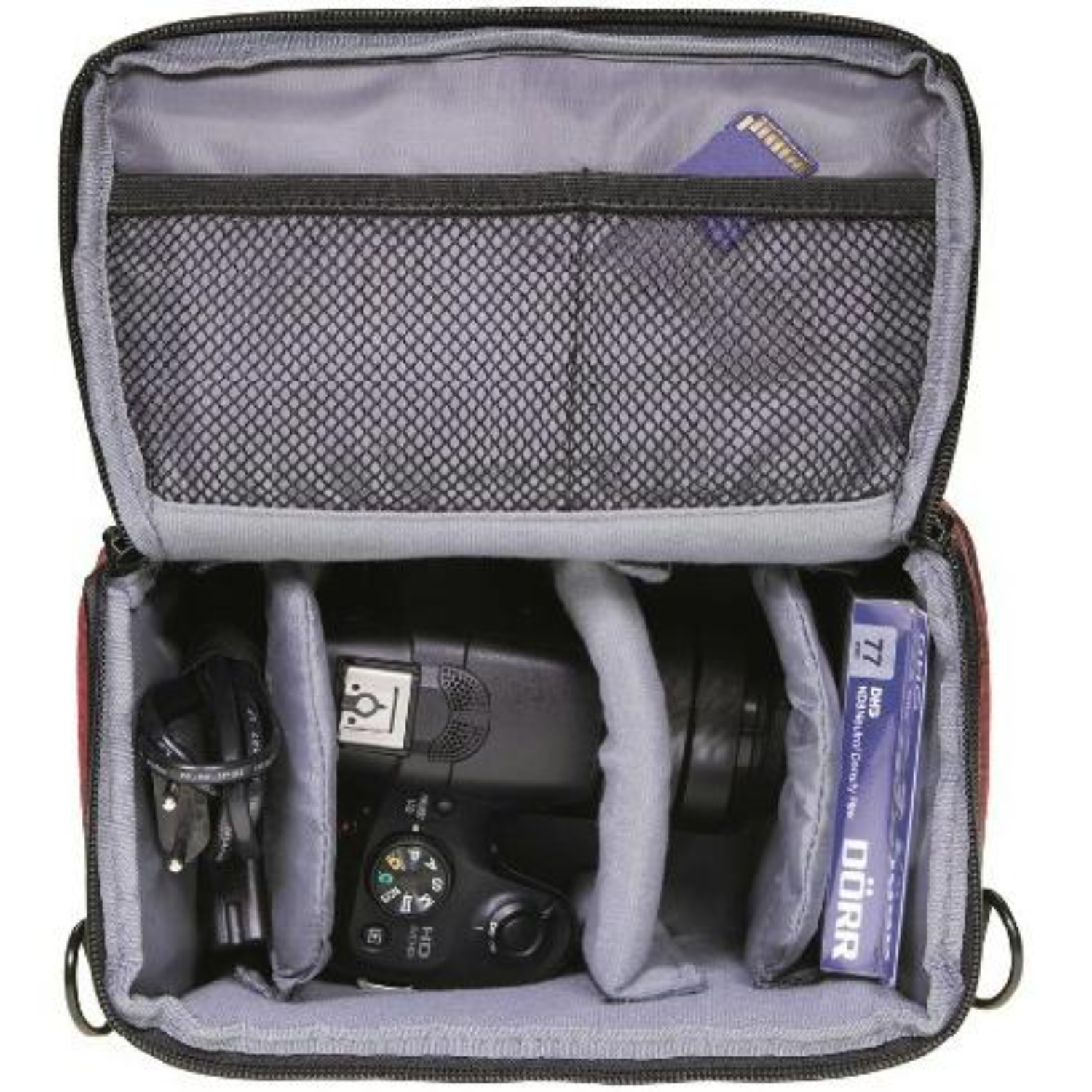 Open camera bag with camera, cables, and a memory card inside.