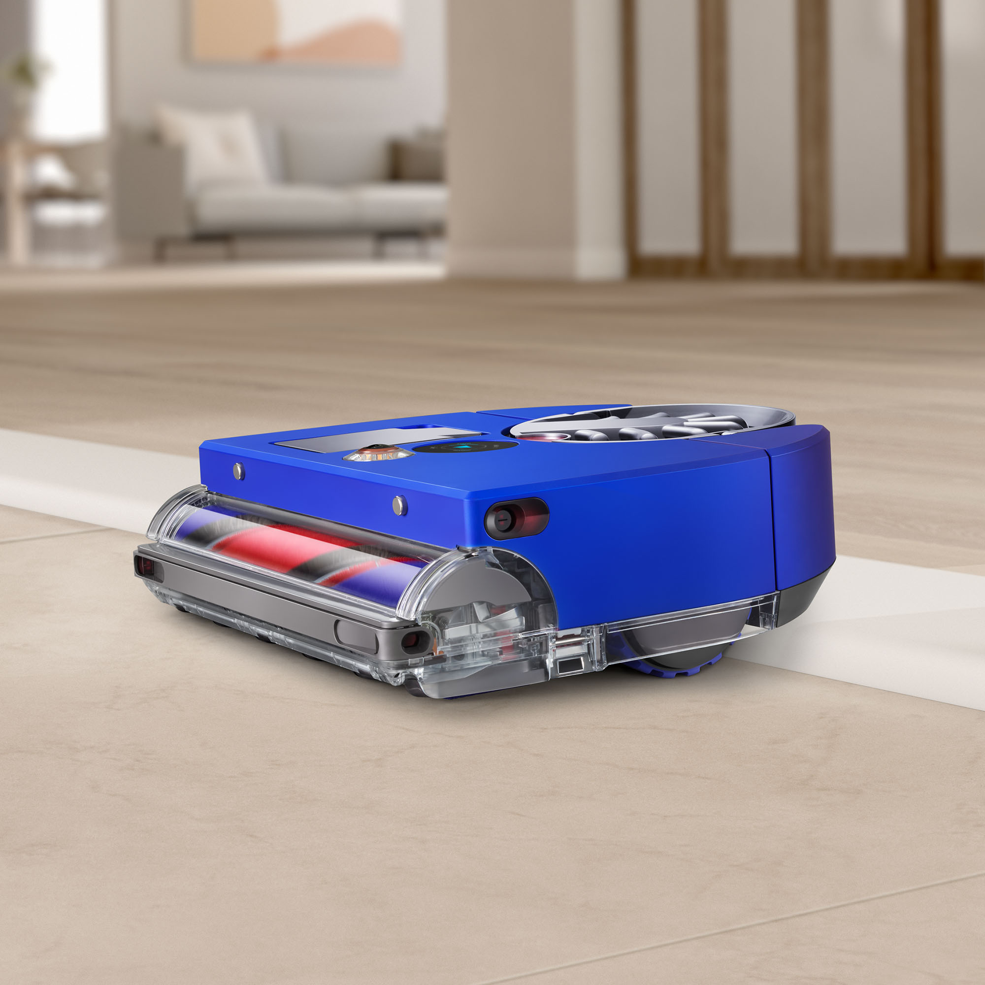 Aspirateur robot bleu sur un sol carrelé beige. Murs blancs en arrière-plan.