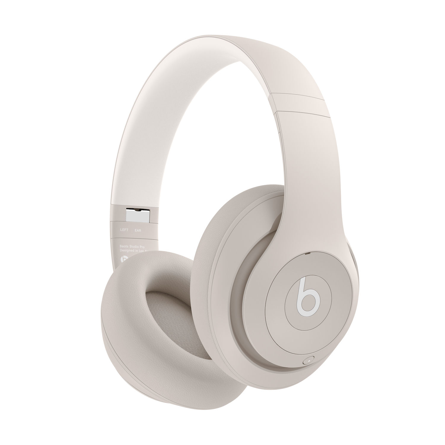 Auriculares beige con almohadillas blancas sobre fondo blanco.