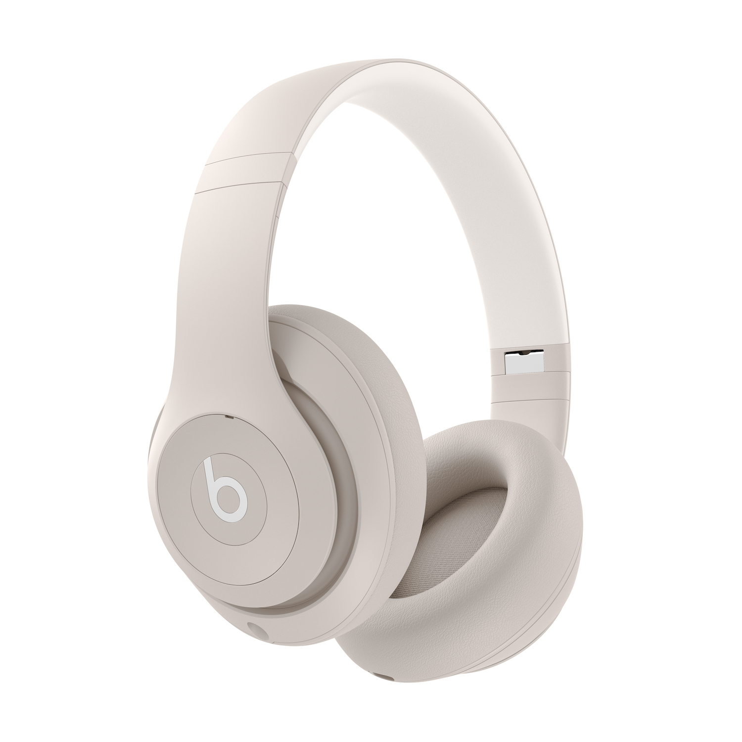 Auriculares Beats beige sobre la oreja sobre un fondo blanco.