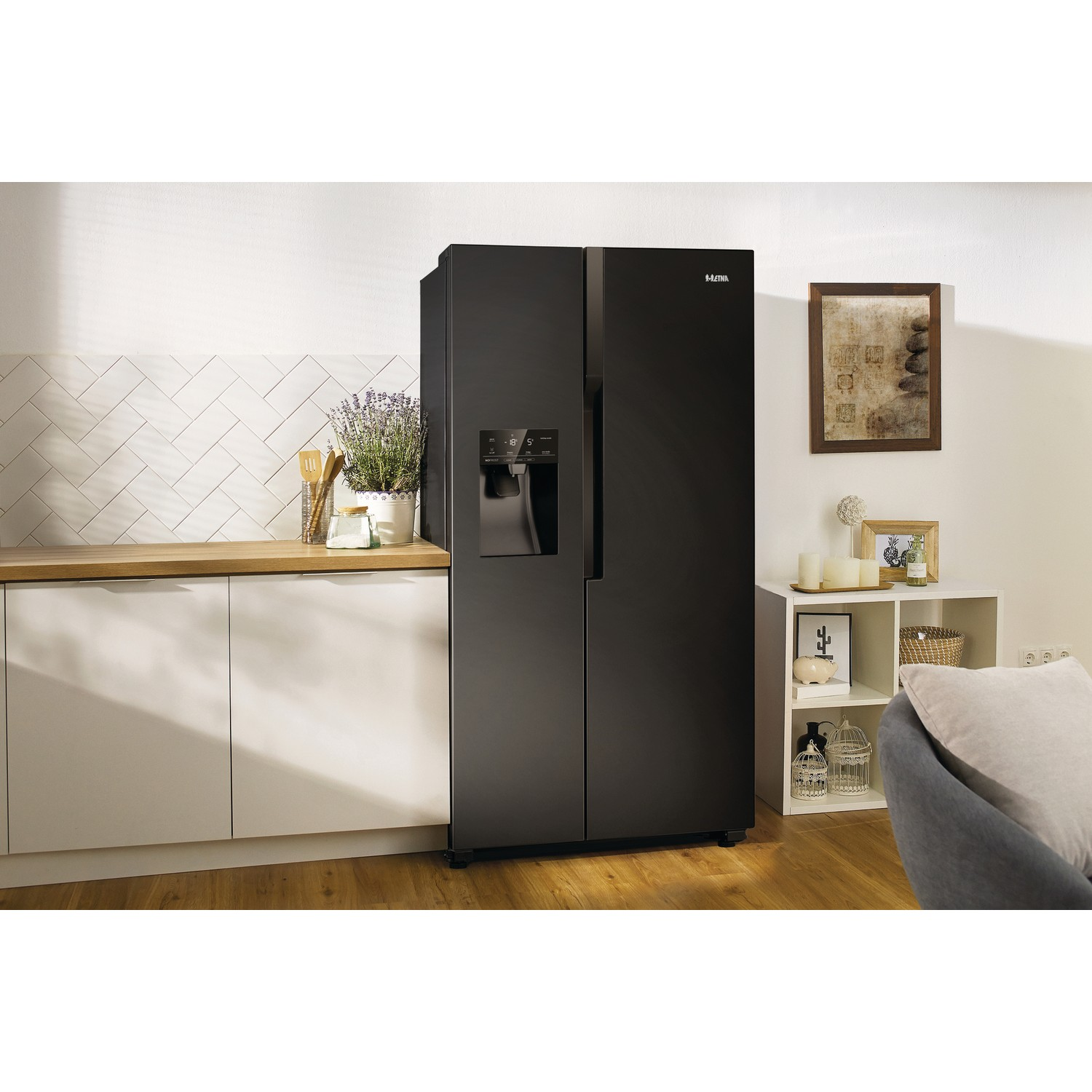 Black side-by-side refrigerator in a modern kitchen setting. White cabinets and wall tiles.