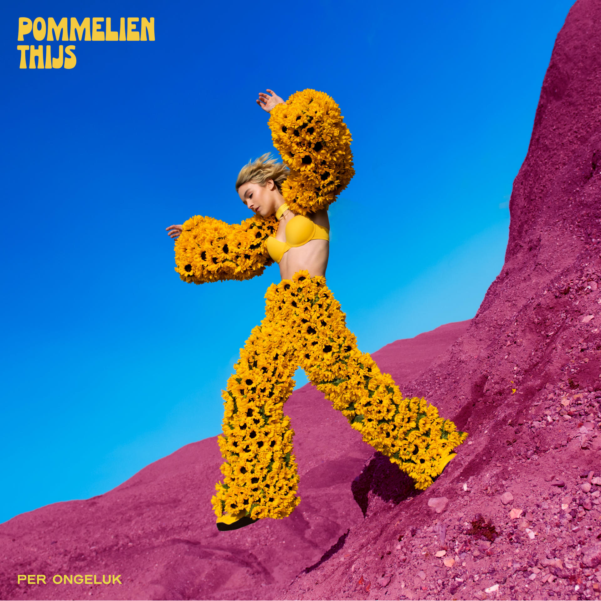 Woman in yellow bra and pants made of sunflowers, blue sky background, and pink ground.