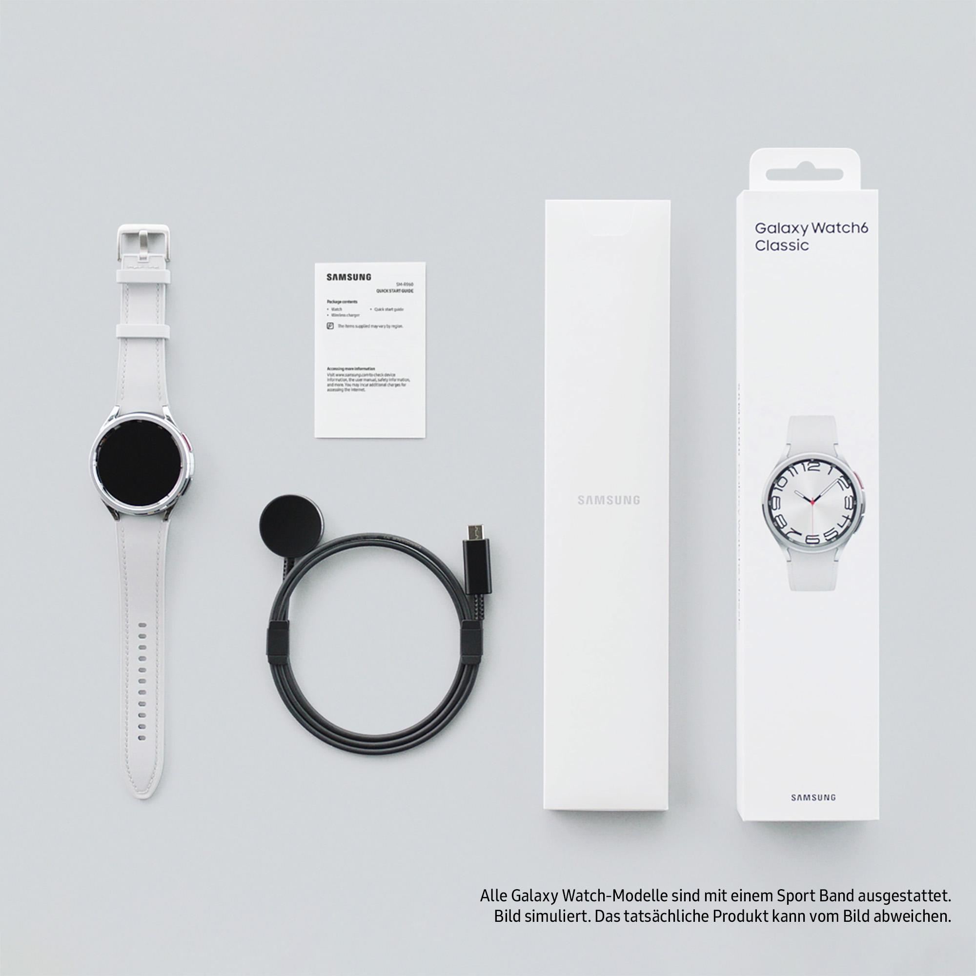 Uhr und Zubehör in einer Box. Weiße Uhr, Ladegerät und Ladekabel auf einer Oberfläche.