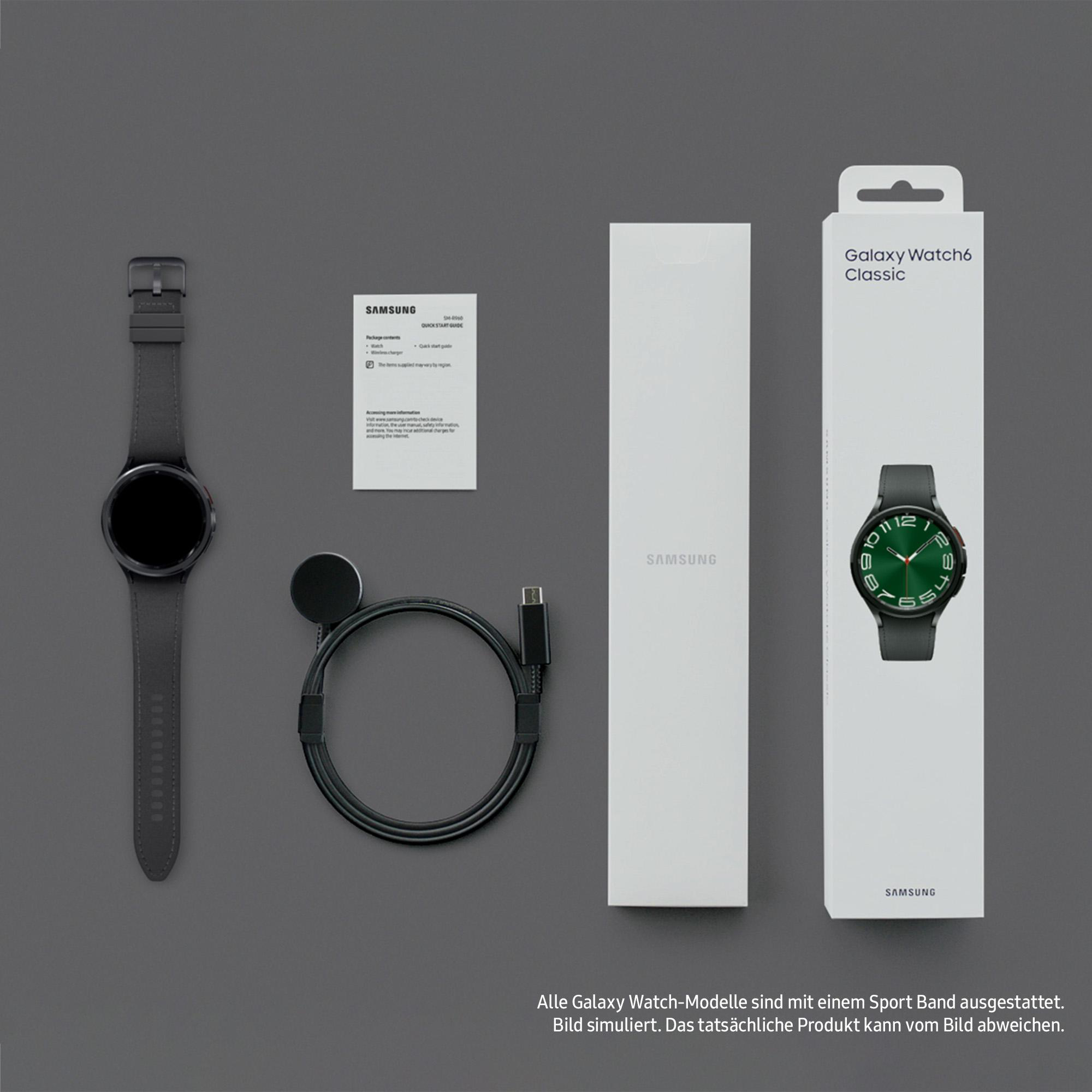 Samsung Galaxy Watch6 Classic: Uhr, Ladepad, Kabel und Box. Alles auf grauer Oberfläche. Sportarmband inklusive.