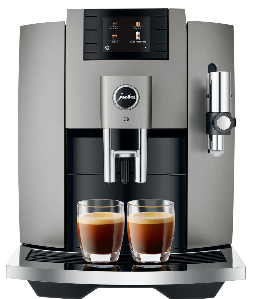 Srebrny ekspres do kawy Jura E8 z dwiema szklankami espresso. Maszyna ma ekran.