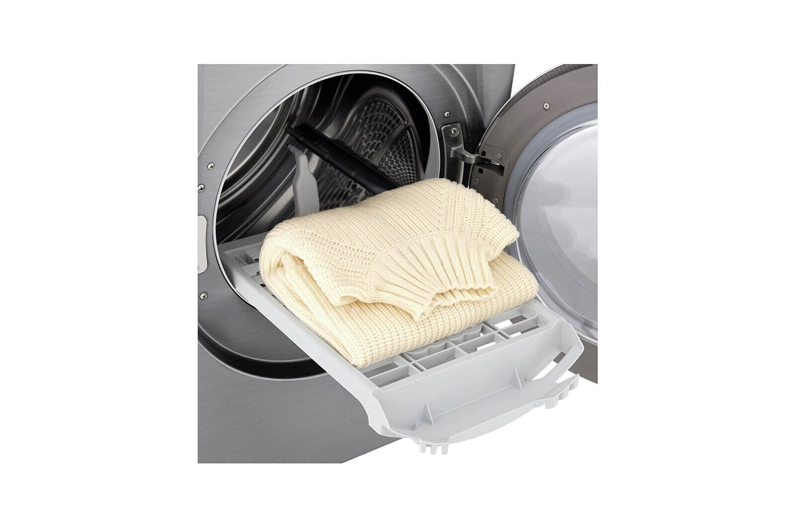 Suszarka z otwartymi drzwiami. Biały sweter umieszczony na białej wysuwanej półce.