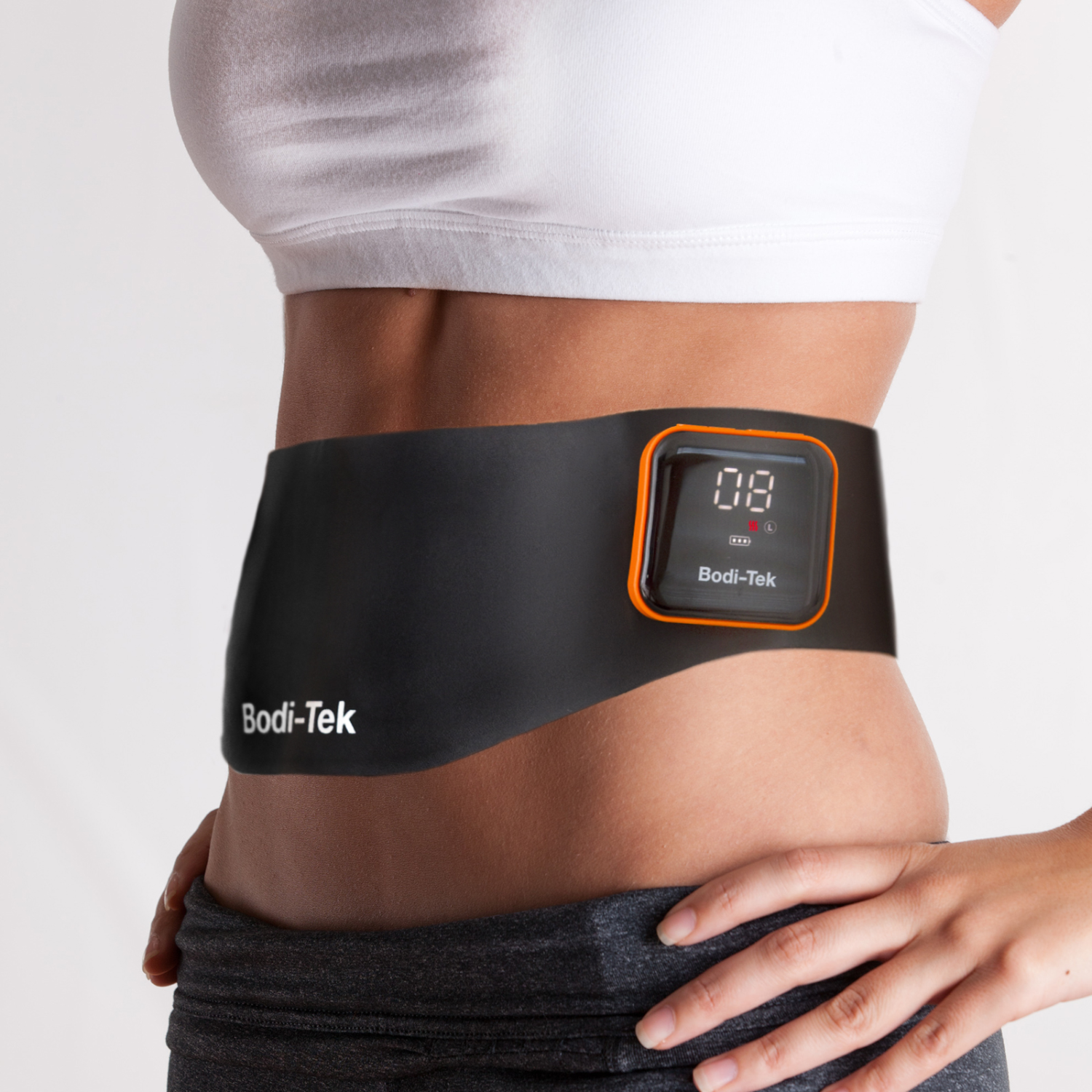 Woman wearing a black Bodi-Tek abdominal muscle stimulator device.