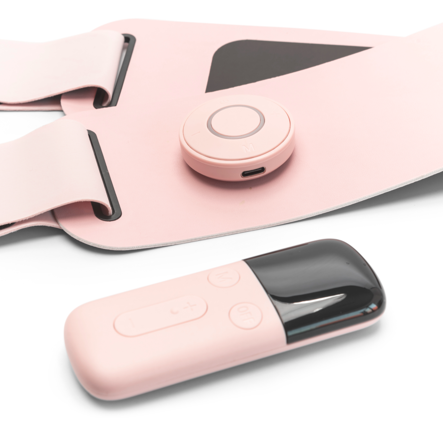 Pink belt with a circular controller and a rectangular remote. White background.