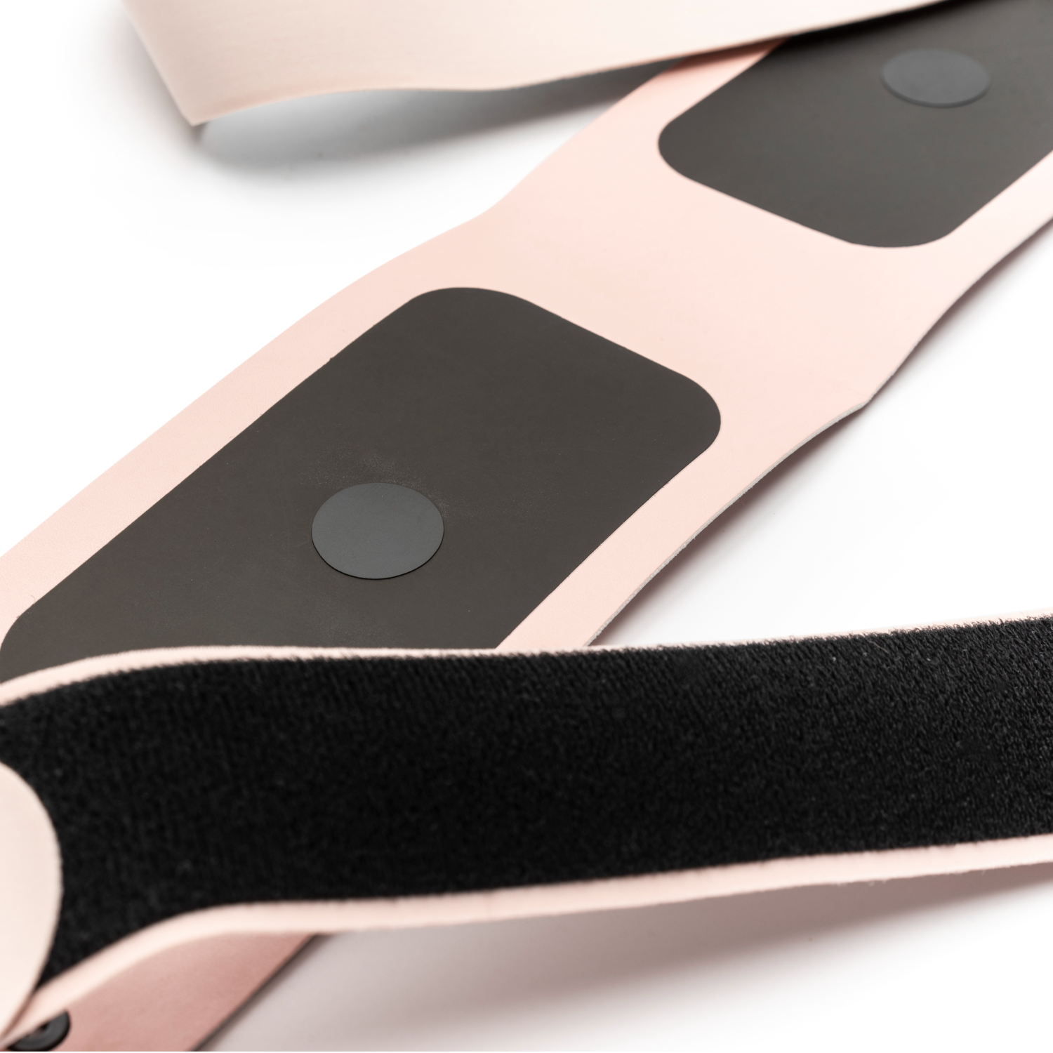 Pink and black EMS muscle stimulation belt.