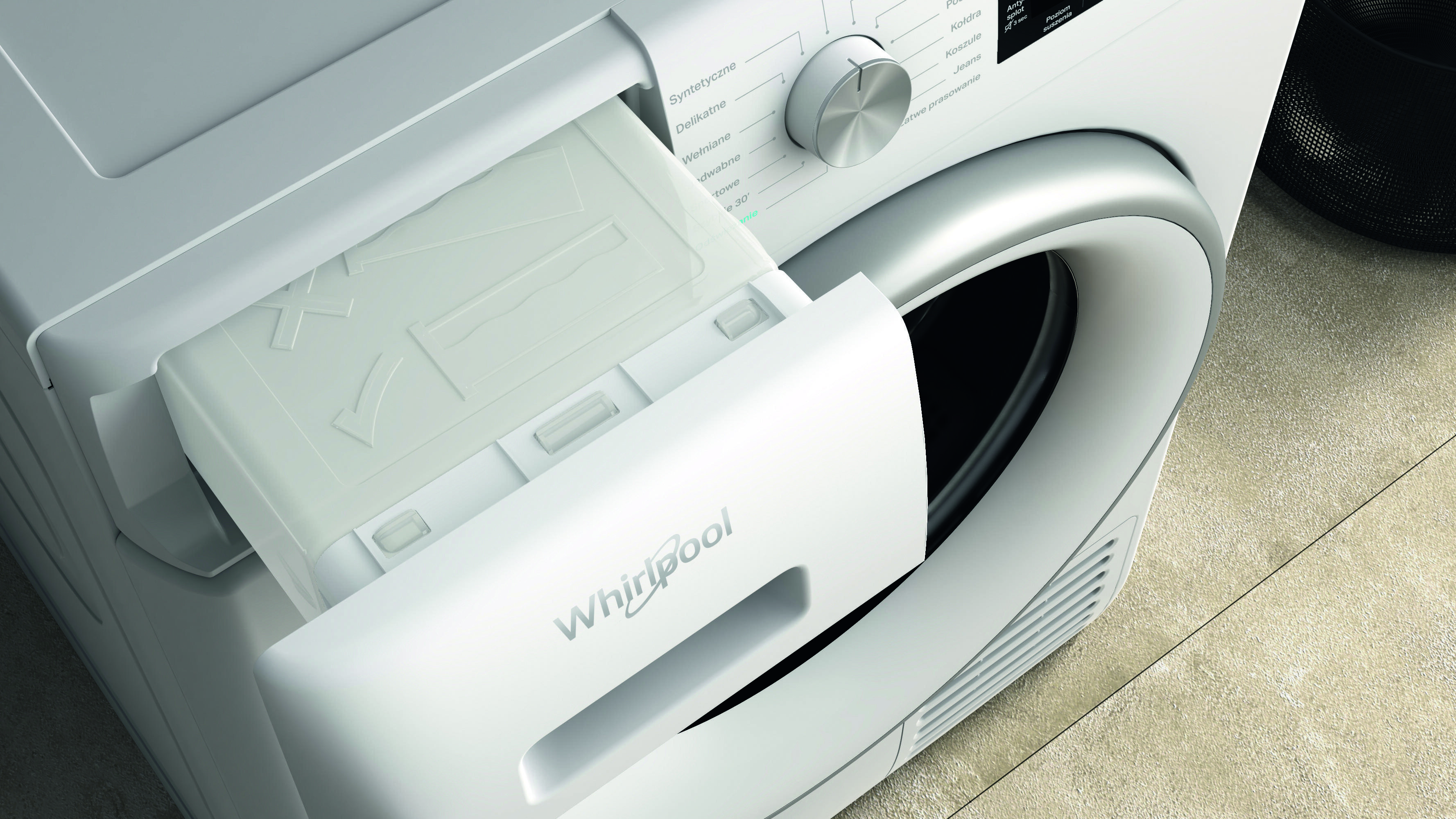 Zbliżenie białej suszarki Whirlpool z otwartą szufladą na detergent. Widoczne ustawienia i elementy sterujące.