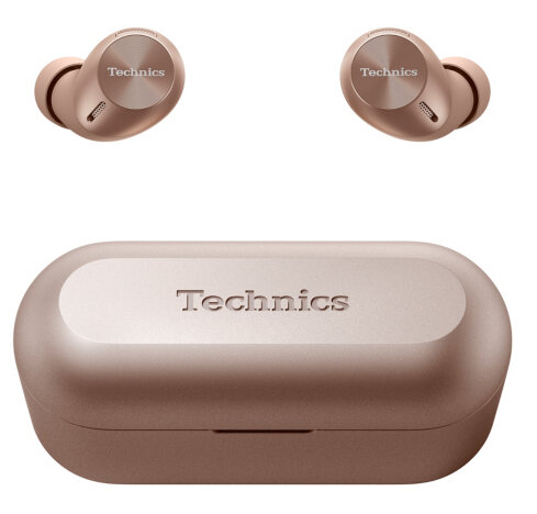 Różowo-złote słuchawki Technics i etui ładujące. Słuchawki nad etui. Etui ma wytłoczone 'Technics'.